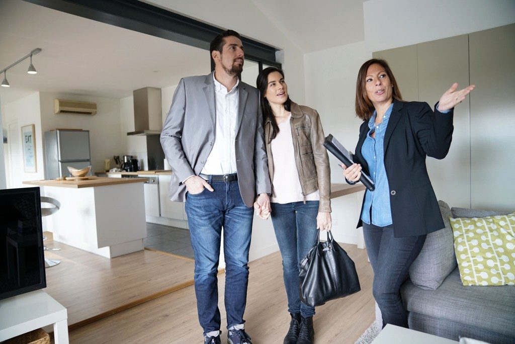 Agent with clients during a house visit