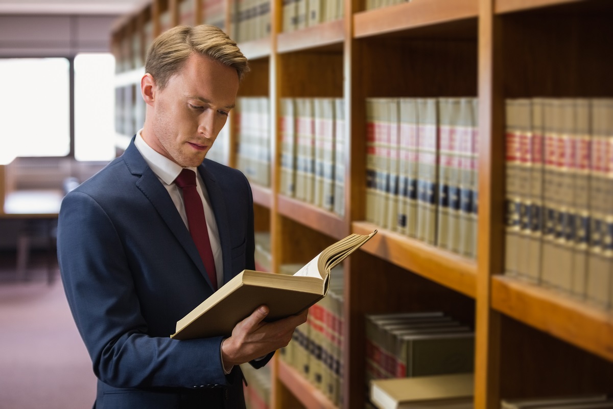 lawyer reading a book in library